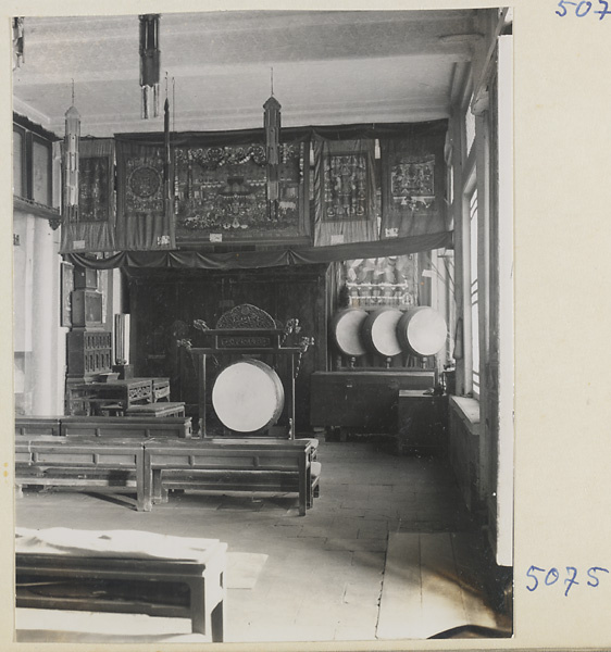 Interior of temple building at Yong he gong showing drums and banners
