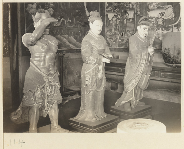 Shrine interior at Hei long tan showing three shrine figures, drums, and details of two murals