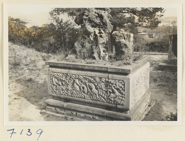 Rock on a stone pedestal with relief panel of animals and waves on Back Hill at Yihe Yuan