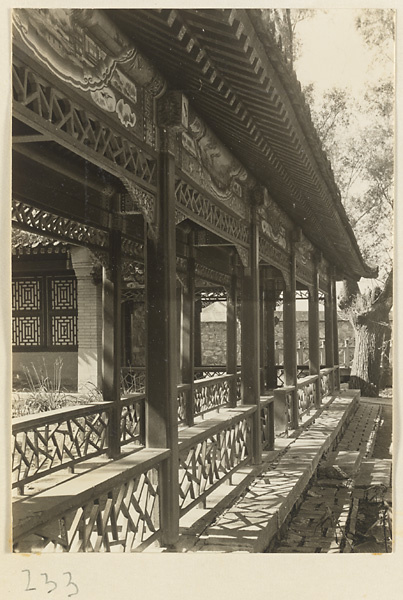 Covered walkway with painted beams and cracked-ice latticework at the New Wu Garden