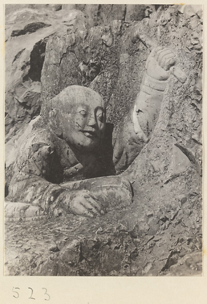 Relief figure holding a sceptre cut into the hillside at Yuquan Hill