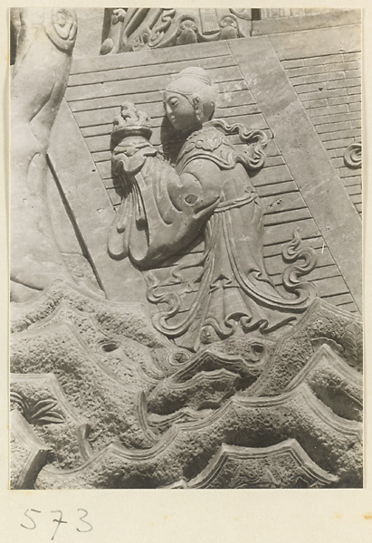 Detail of a pagoda showing a relief carving with a Buddhist figure at Huang si