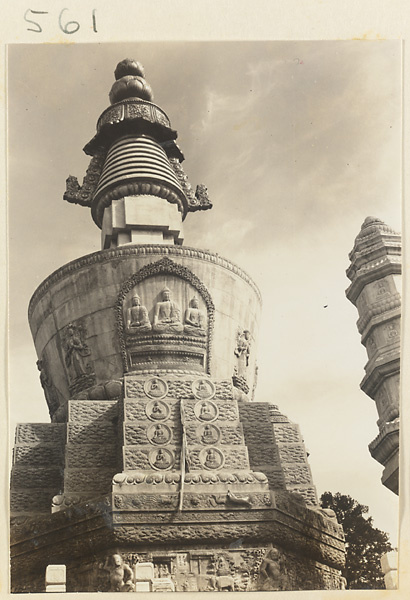 Detail of stupa-style pagoda at Huang si showing carved relief work with Buddhist figures and scenes