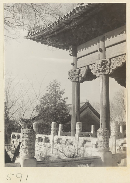 Detail showing columns with animal-head capitals at corner of double-eaved temple building at Huang si