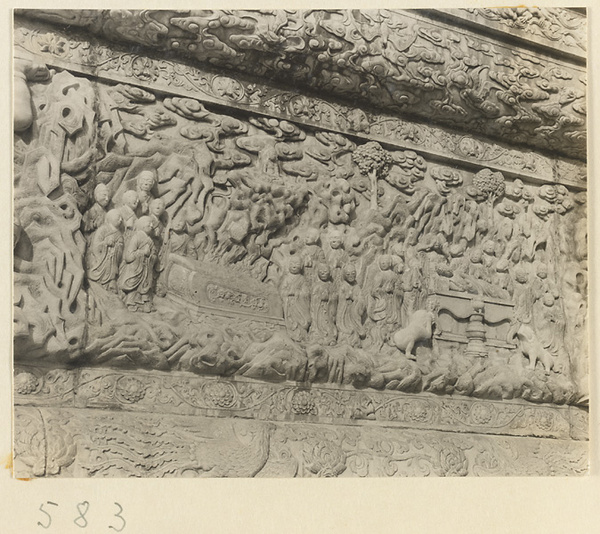 Detail of a pagoda showing a relief carving with a Buddhist scene at Huang si