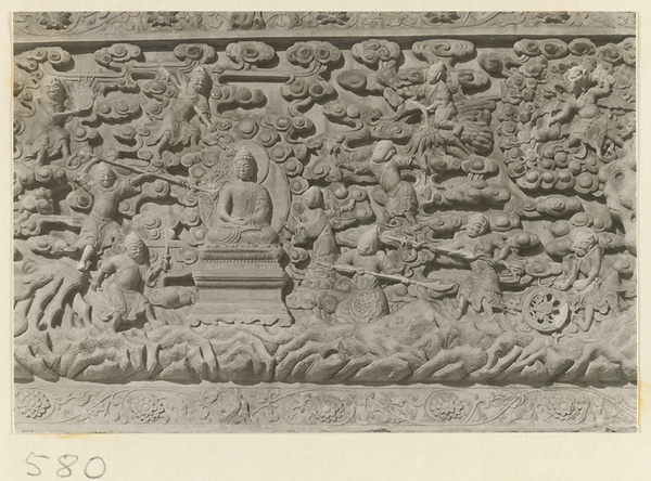 Detail of a pagoda showing a relief carving with a Buddhist scene at Huang si