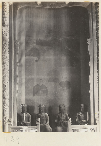 Temple interior showing niche with four Daoist statues and a painting at Bai yun guan