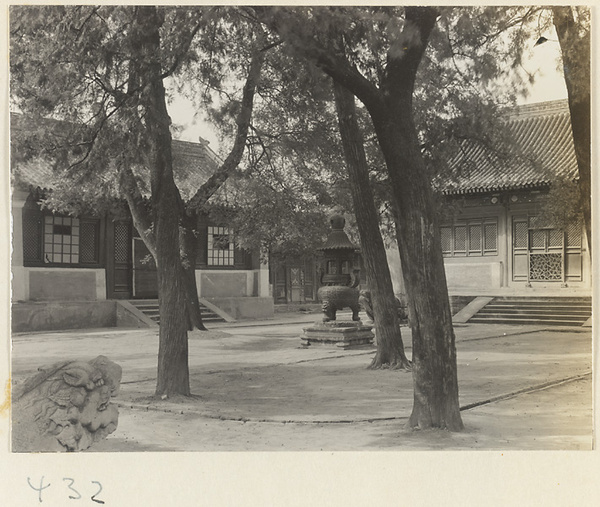 Temple buildings and courtyard with trees, incense burner, and tortoise stelae at Bai yun guan