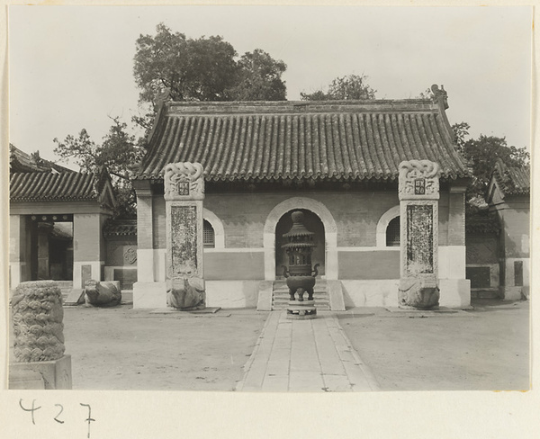 Temple building and courtyard with tortoise stelae and incense burner at Bai yun guan