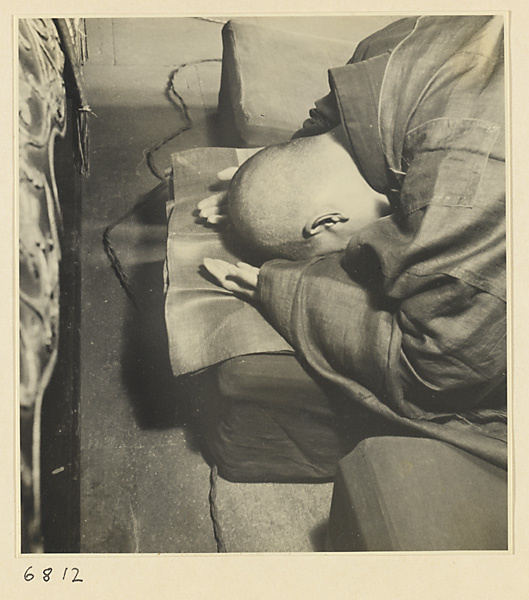 Buddhist nun prostrate at altar