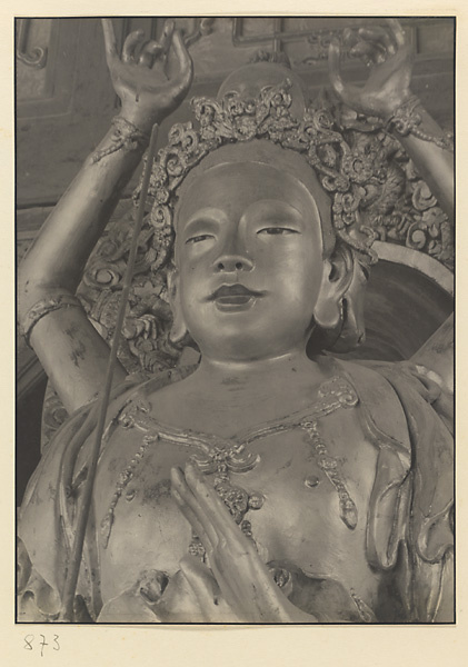 Interior of Wan shan dian showing detail of shrine figure with eight arms seated on a carved animal