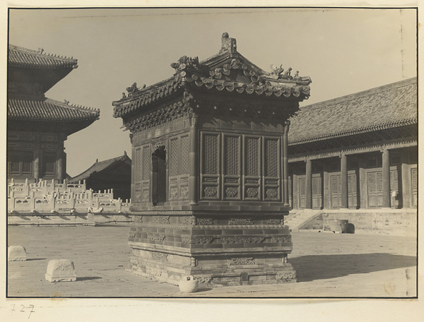 Glazed-tile sacrificial stove for burning paper and silk offerings and marble flagpole holders in the main courtyard at Tai miao