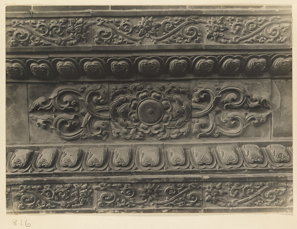 Detail of base of Jiu long bi showing glazed tiles with floral motifs