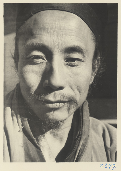 Daoist priest wearing a hat at Bai yun guan