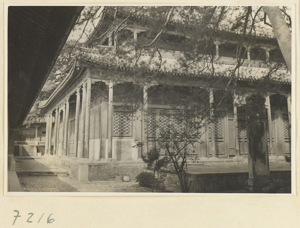 Stone stela in front of a two-story, double-eaved temple building at Jie tai si