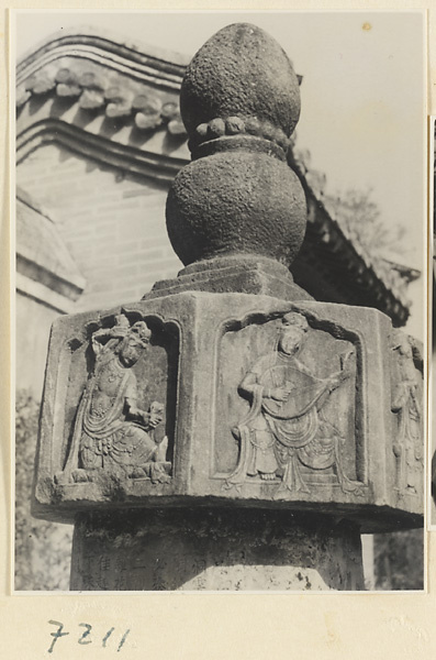 Detail showing carved relief figures on a free-standing stone column at Jie tai si