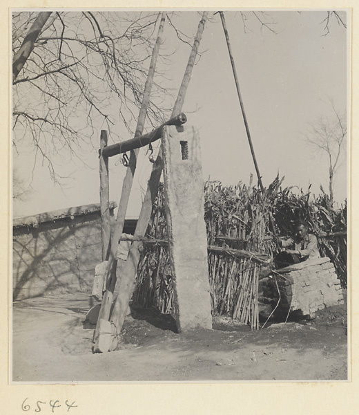 Man with a bucket at a well