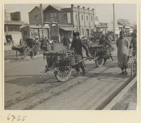 Street with vendors' carts, rickshaws, and bicycles