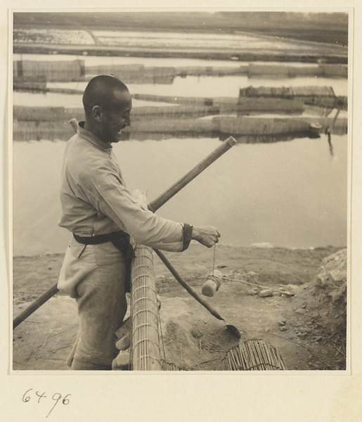 Man weaving a door curtain