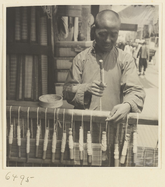 Man weaving a door curtain