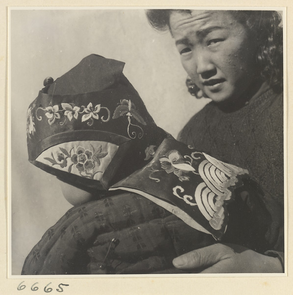 Woman and child wearing an embroidered hat