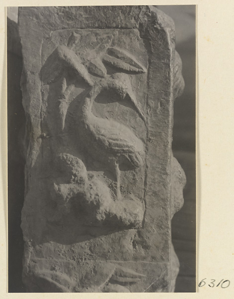 Carved door stone with bird motif