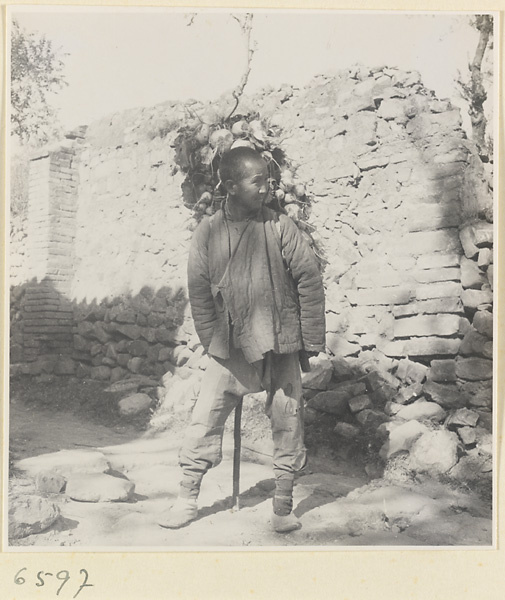 Man carrying a load of root vegetables