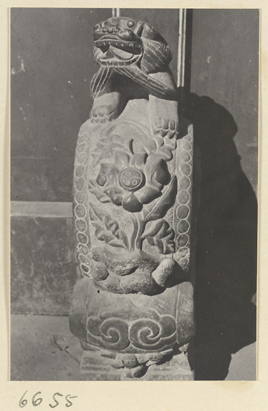 Carved door stone with floral and ling zhi fungus motifs and animal finial