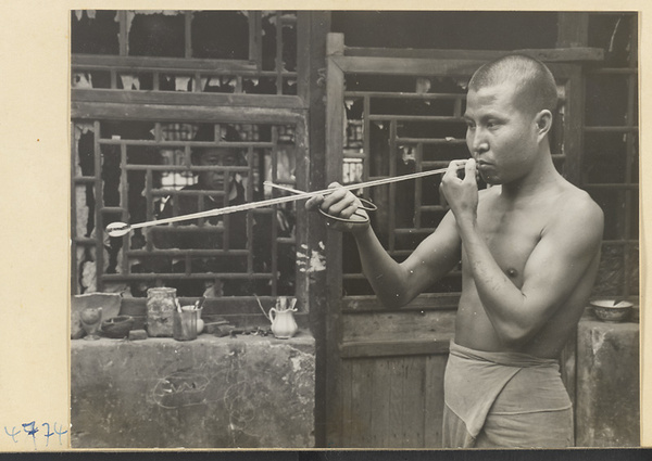 Man blowing glass in a workshop