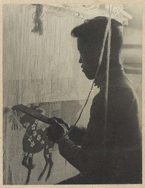 Carpet weaver working at his loom