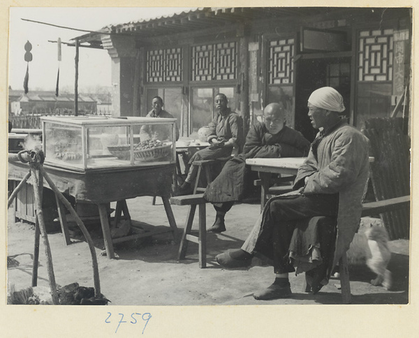 Food vendor's stand with customers and shop signs