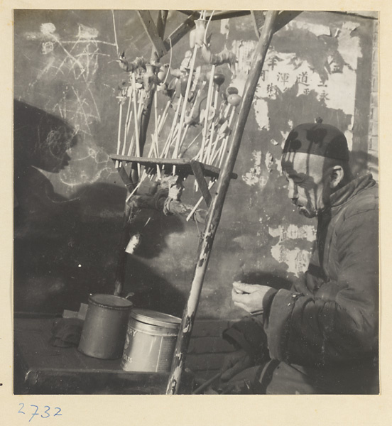 Candy vendor at his stand making blown candy