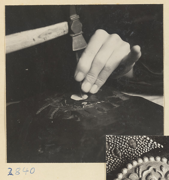 Silversmith making a silver button in a shop