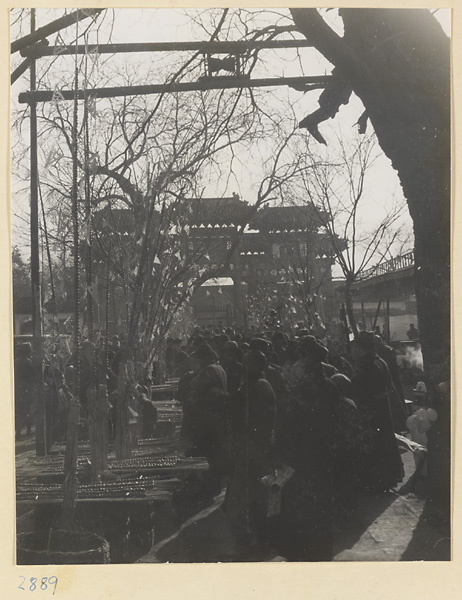 People in the street near a pai lou at New Year's