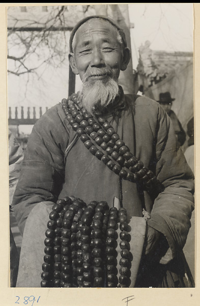 Street vendor hawking 佛珠 (Buddhist prayer beads) at New Year's