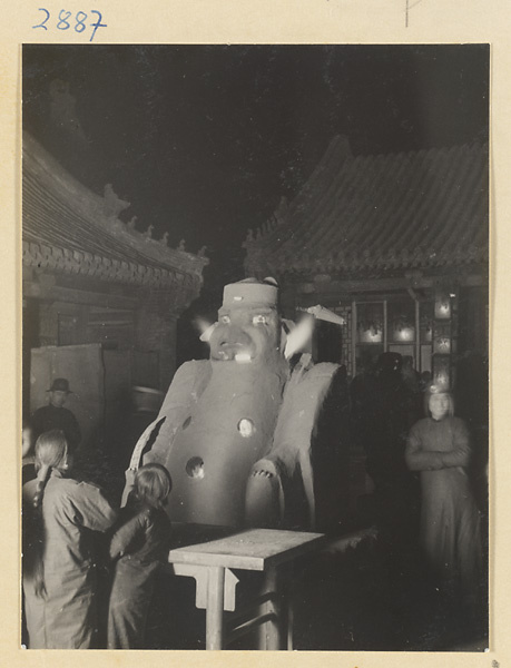 Large hollow statue of the Fire God filled with burning coals in Cheng huang miao courtyard at New Year's