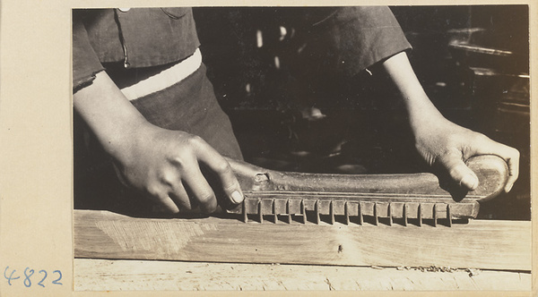 Furniture-maker planing a piece of wood, Furniture Street, Peking