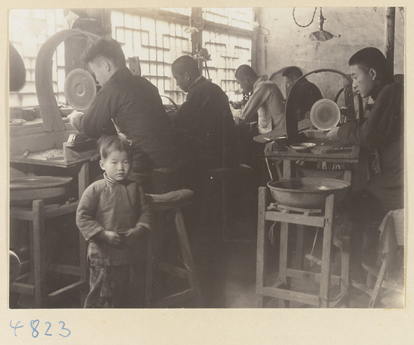 Men using grinding wheels to polish jade in a workshop