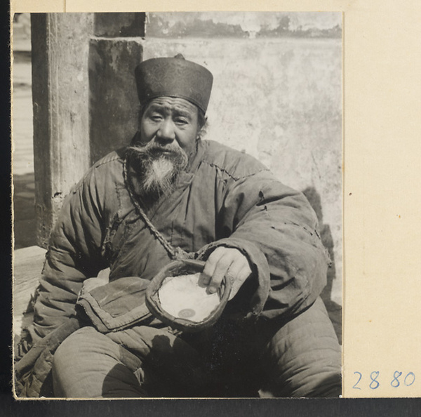 Man collecting alms at New Year's