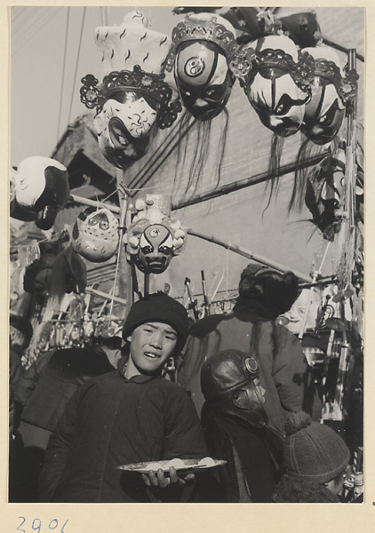 Street vendor selling opera masks at New Year's