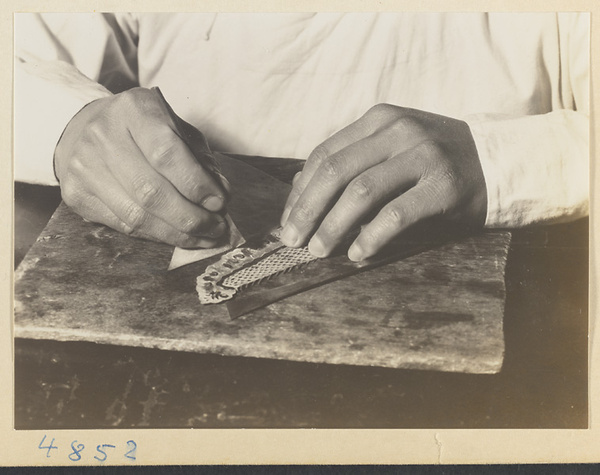 Man making a shadow puppet