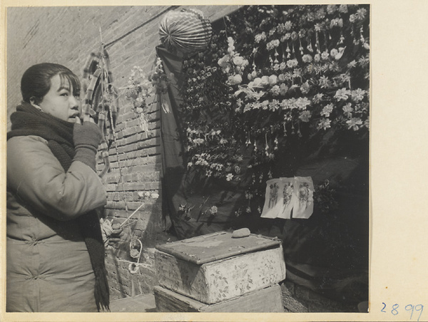 Woman at a stand selling paper flowers at New Year's
