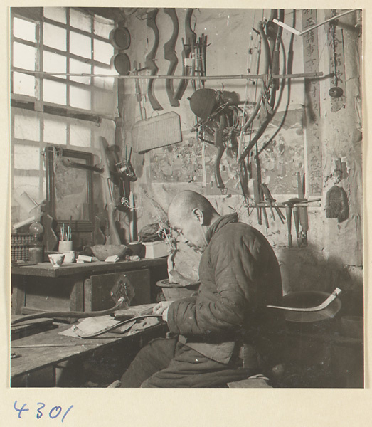 Man making a bow in a bow-and-arrow-making shop