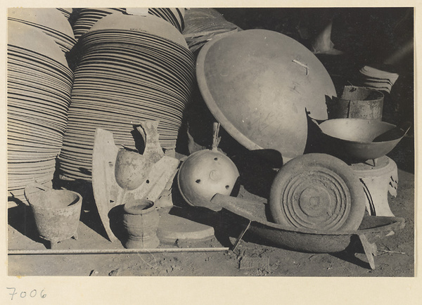 Iron cooking pots stacked up at a foundry near Mentougou Qu