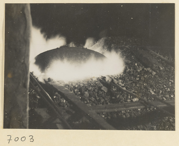 Metal being heated in a forge in a wheel-making shop