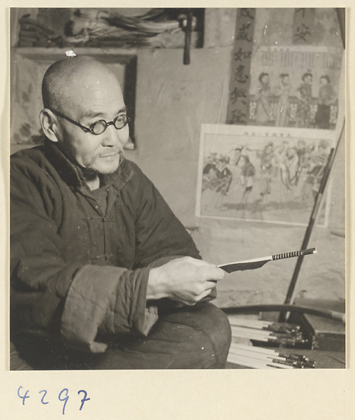 Man making an arrow in a bow-and-arrow-making shop