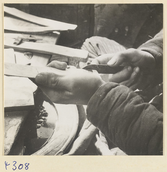 Man at work in a brush-making shop