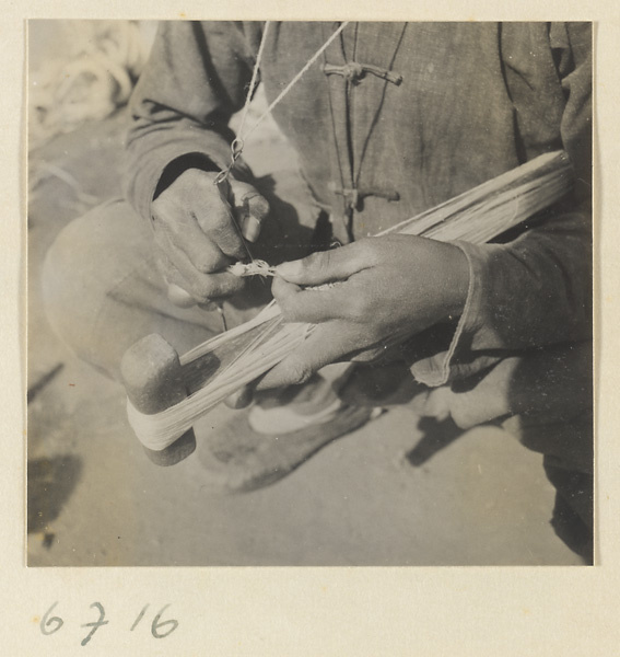 Silk spinner tying off a skein of silk