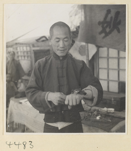 Street doctor's stand showing a patient with a poultice on his hand