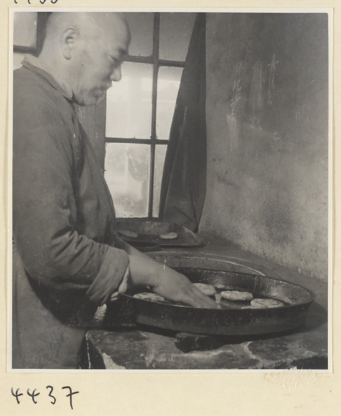 Kitchen of Niu Rou Wan, a Muslim grilled-beef restaurant, showing a chef frying dough